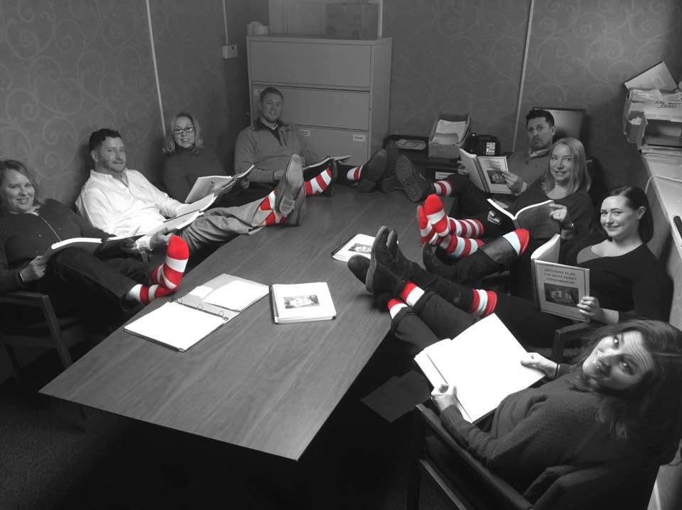 Community group showing off red and white striped socks